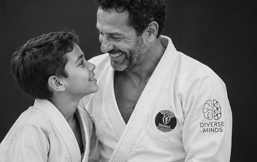 Close, candid black-and-white shot of an early one-on-one session, hands adjusting grip, unposed