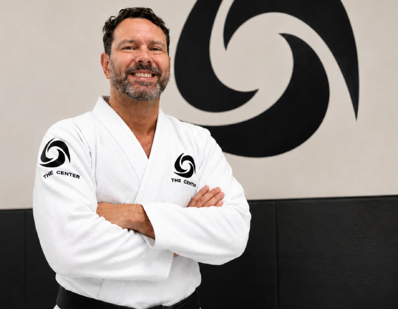 Black-and-white portrait of Marcio Sarmento mid-instruction on the Jiu-Jitsu mat