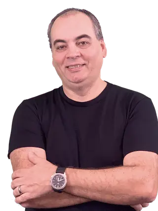 Julio Rocha seated at a desk with a laptop, smiling